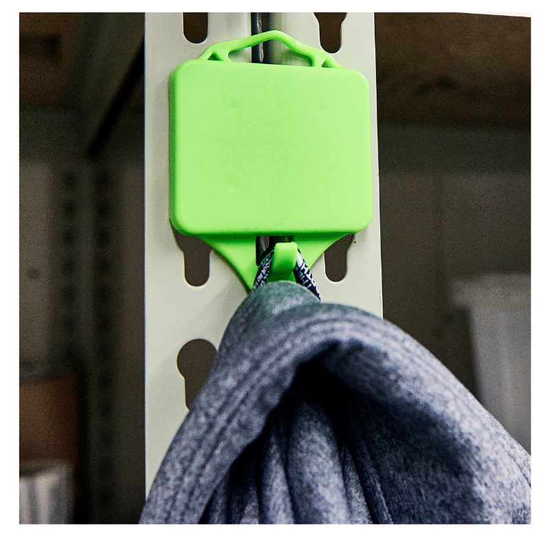 green magnet hook holding jacket