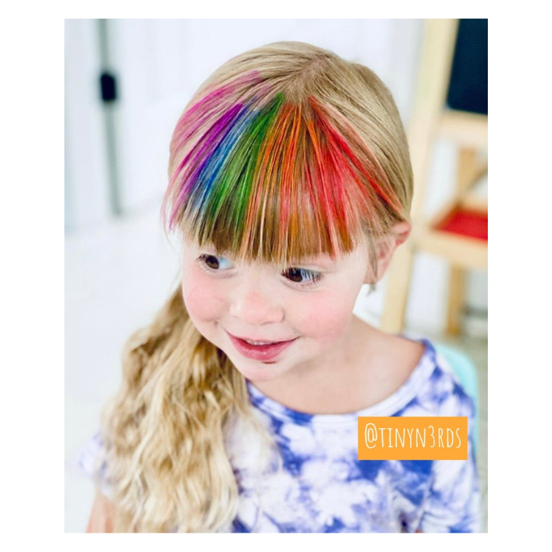 little girl with rainbow colored hair chalk